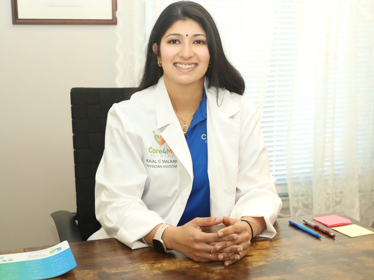 Kajal Malkan, DMSc, MPAS, PA-C, at her desk in the Care4Me Clinics office